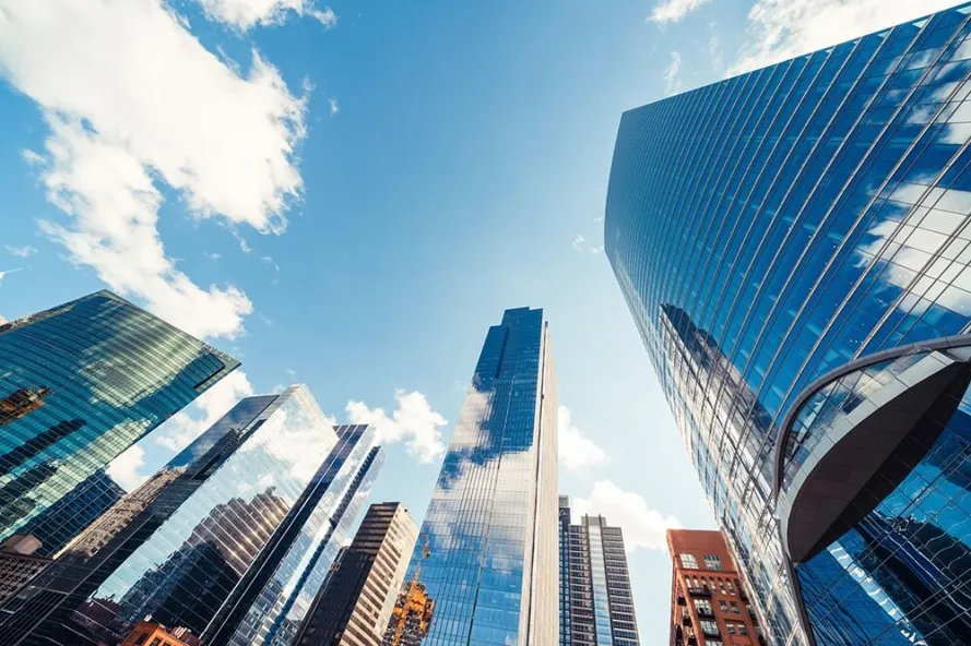 Perspective view looking up toward sky with modern buildings in foreground.