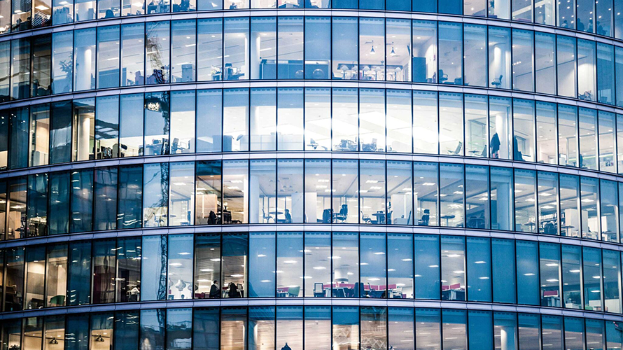 Gridwork of illuminated office building windows..