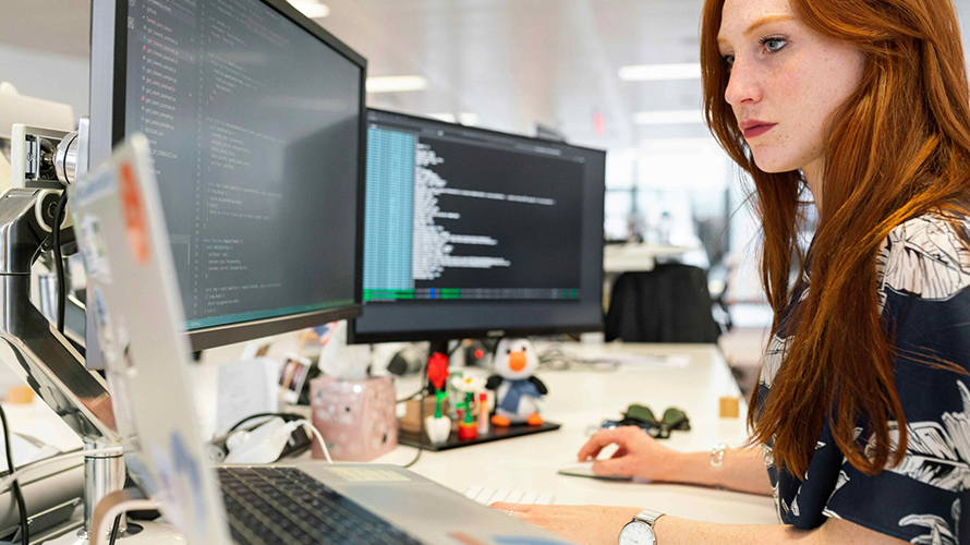 Woman coding at a computer